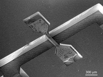 A stainless steel micro tensile specimen in a silicon frame.