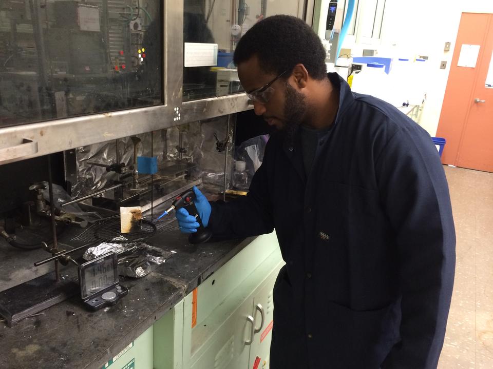 GMSE graduate student Andre Thompson in one of NIST's Fire Research laboratories, testing the flammability of materials