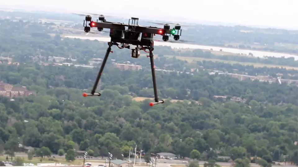Quadcopter flying in the air over trees