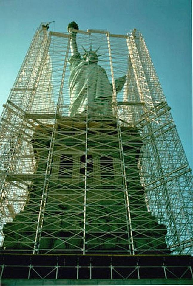 An exterior photo of the Statue of Liberty surrounded by scaffolding