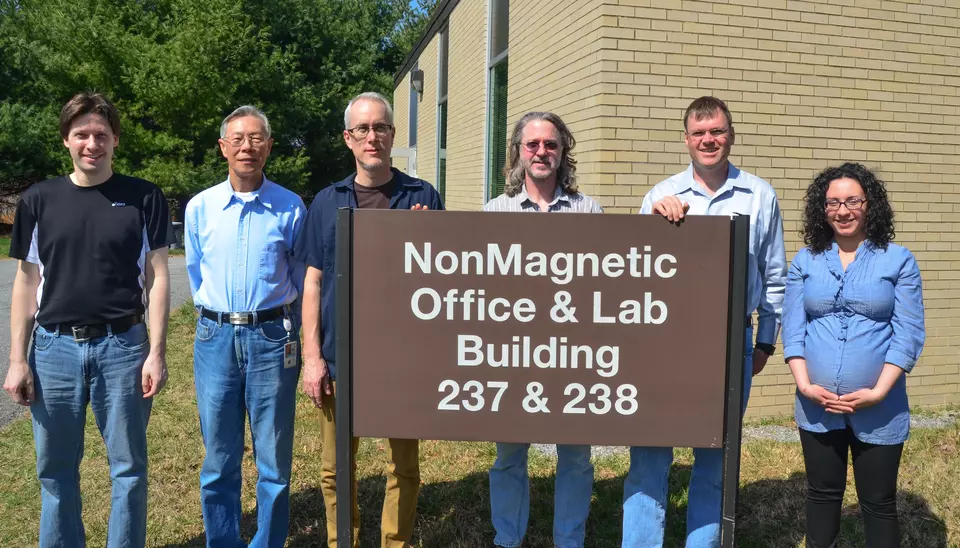 Several of the napkin signers in 2013. From left to right, Frank Seifert, Ruimin Liu, Jon Pratt, Dave Newell, Stephan Schlamminger, and Darine Haddad (+1).