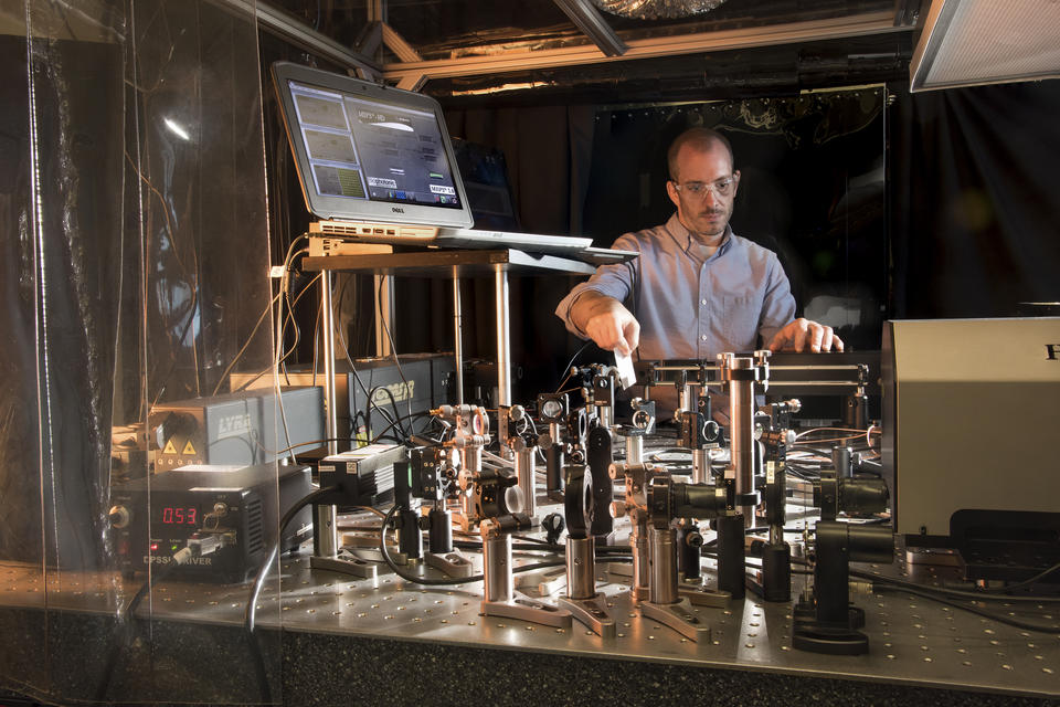 Researcher John Bender setting up a laser table in a laboratory