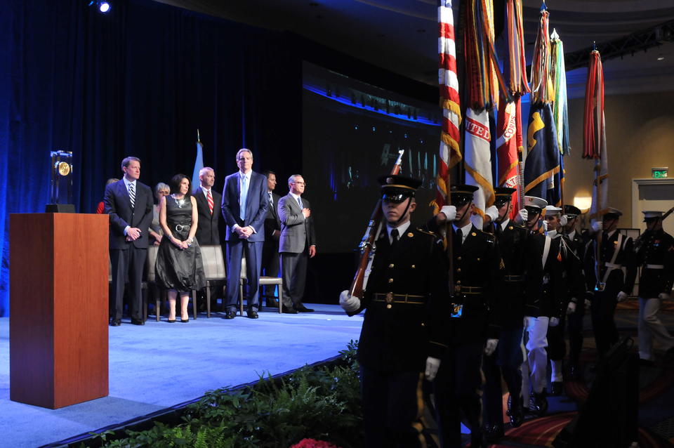 eaders of 2014 Baldrige Award recipient organizations and Commerce Department Deputy Secretary Bruce Andrews watch the procession of the United States Joint Service Color Guard during the Baldrige Award Ceremony on Sunday, April 12, 2015.