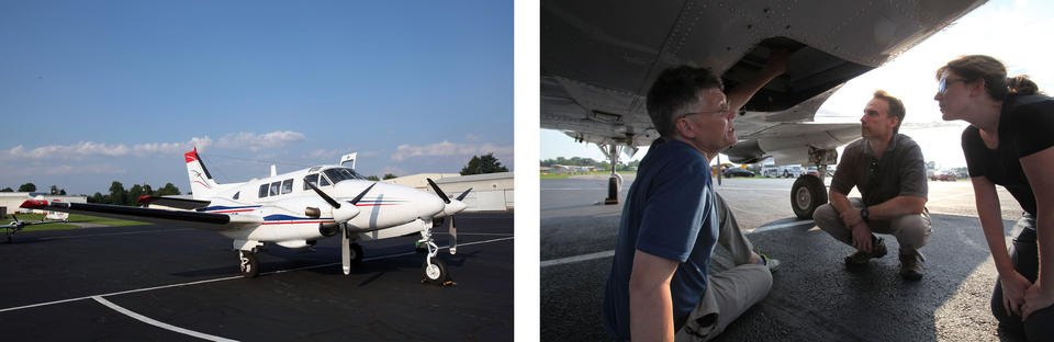 Three scientists crouch below the belly of an aircraft.