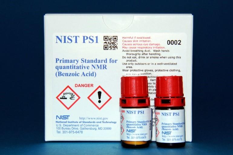 Photograph of NIST PS1 Primary Standard for Quantitative NMR (Benzoic Acid) showing labeled box and two labeled bottles. 