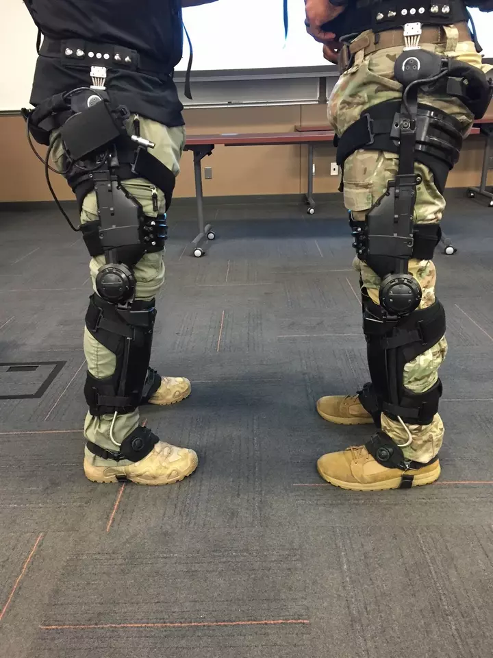 The legs of two soldiers with exoskeletons