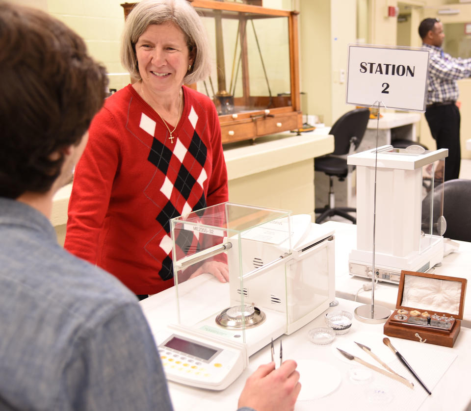 Carol Hockert stands at a table.