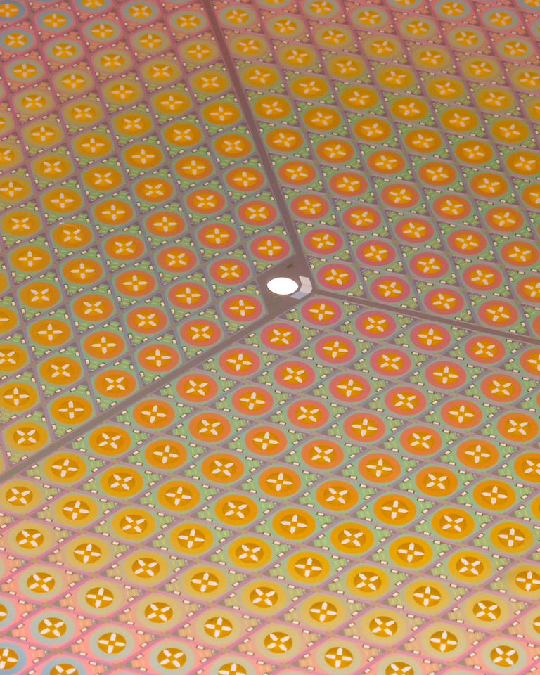 cropped image of the surface of a silicon wafer containing many rhomboidal-shaped tiles.