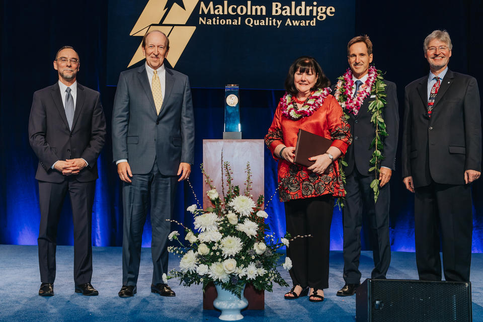 5 people standing on a stage