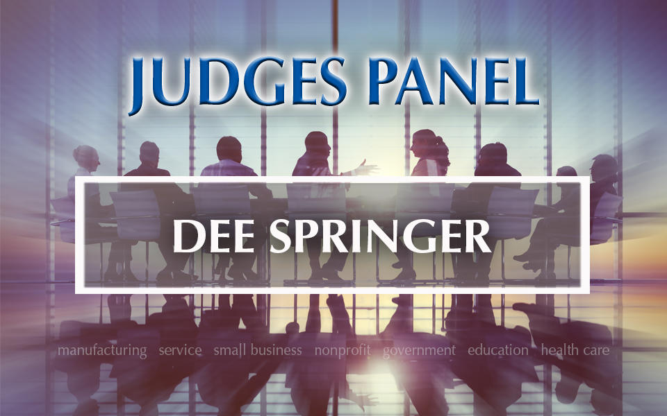 Judges Panel Dee Springer with photo in background of people meeting at a table.