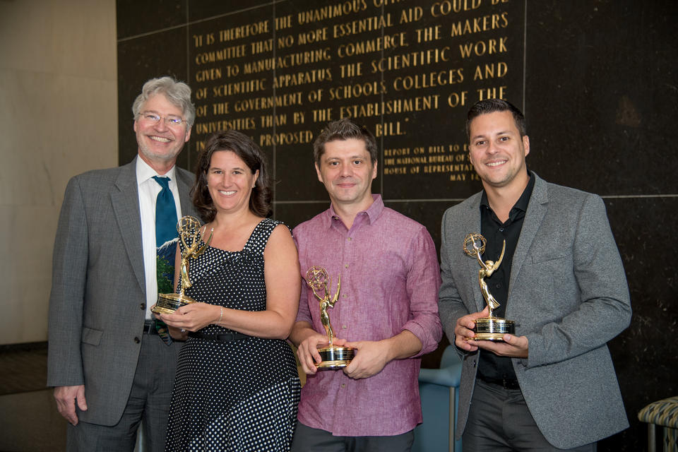 NIST Director along with three staff members holding an Emmy Award