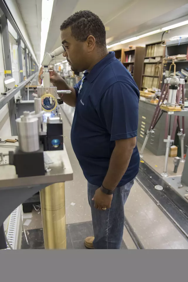 A scientist looking in a microscope