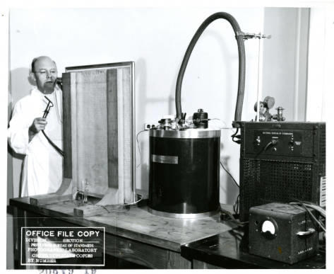 EC Creitz of NBS sealing the inlet tube from the helium_humidifier to the short tube leading into the enclosure