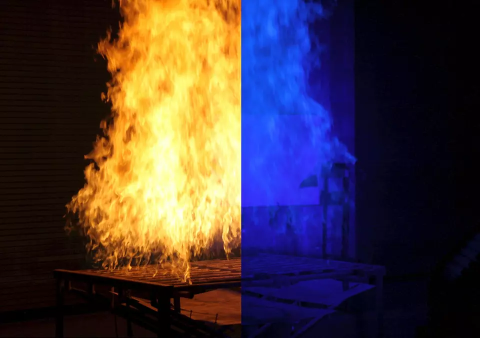 In this photo, we see a split-screen image of a laboratory fire. The left side shows the fire obscuring the view of an object behind it while the right side shows the same object with the clarity dramatically enhanced using ordinary blue light.