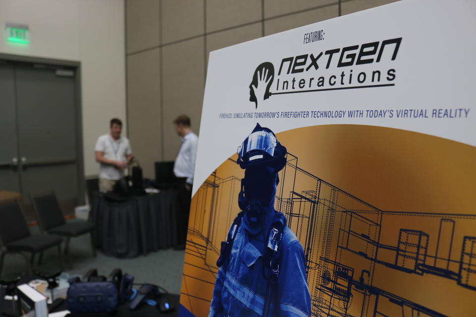Virtual Reality set up in the background with a poster in the foreground showing a first responder in a virtual environment