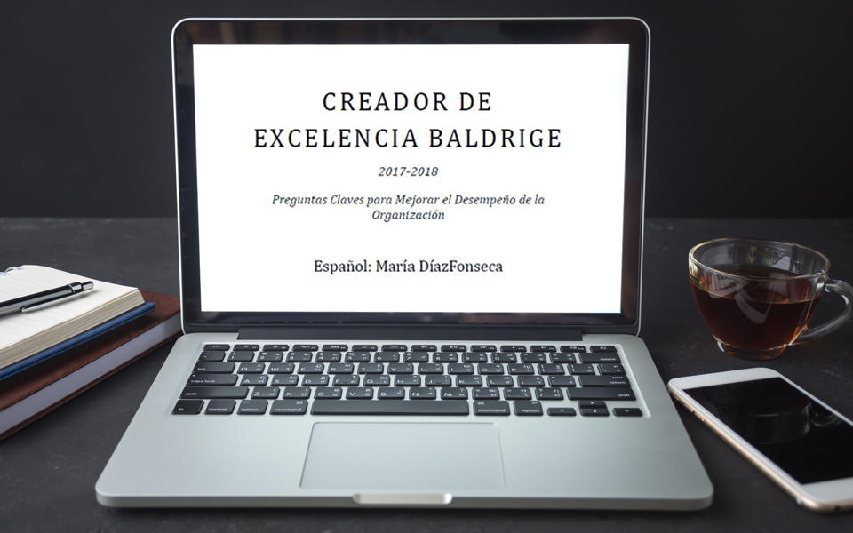 Laptop sitting on desk showing the first page of the Baldrige Excellence Builder translation.