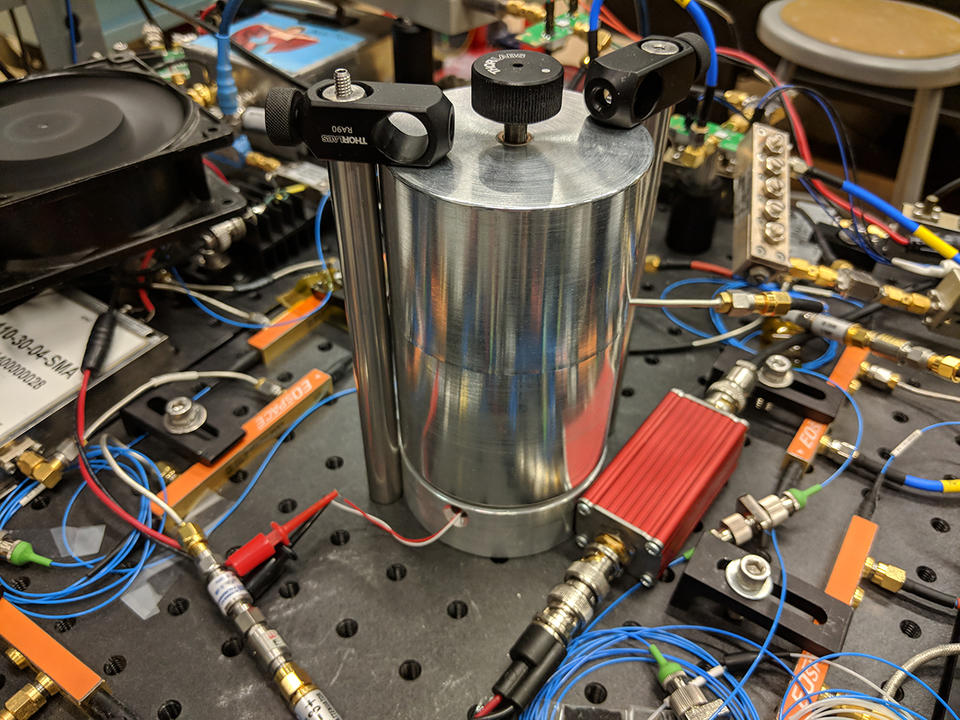 Tall silver cylinder surrounded by wires