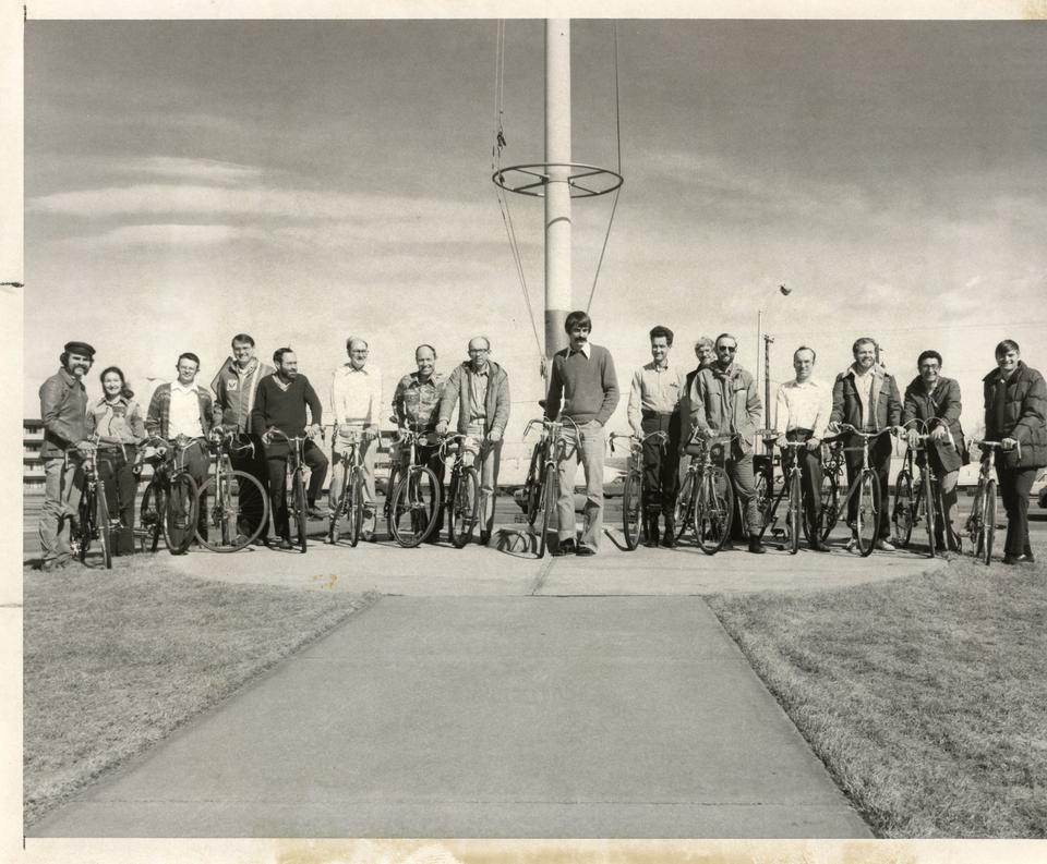 A group of 16 people with their bikes