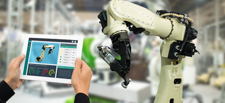 manufacturer with an ipad controlling a robot