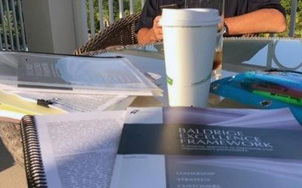 Baldrige Examiner Christy Hunter with the Baldrige Excellence Framework at Beach.