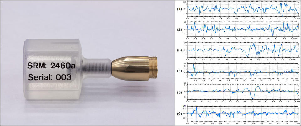 NIST Standard Bullet with Data A copper colored bullet in a plastic holder