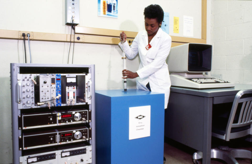 Photo of Jackie Calhoun with an Ionization Chamber.