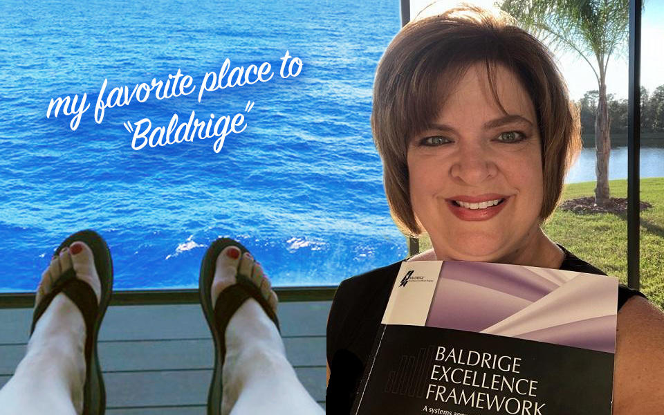 Baldrige Examiner Theresa Trivette holding a Baldrige Excellence Framework Health Care in Florida at the beach her favorite place to "Baldrige".