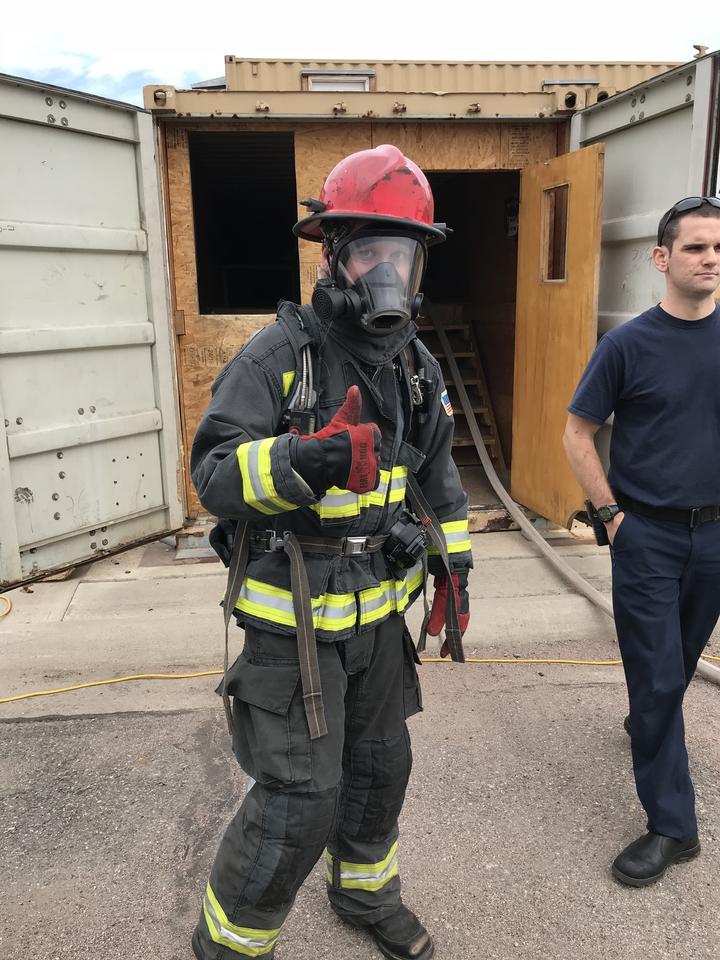 NIST "firefighter" in full gear giving the "thumbs up."