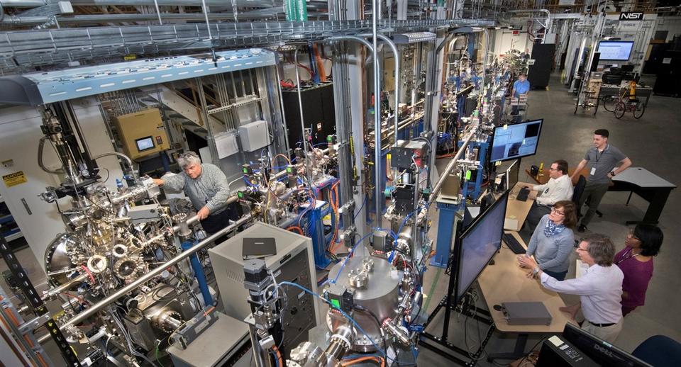 The NIST Synchrotron Science Group working at the SST-I (middle front) and SST-II (front left) beamlines. In the background, the safety hutch for the hard X-ray beamline BMM can be seen (top right).