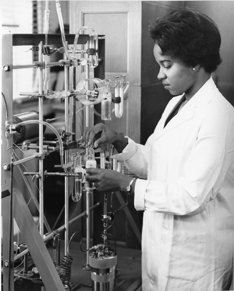 A woman working at a lab bench