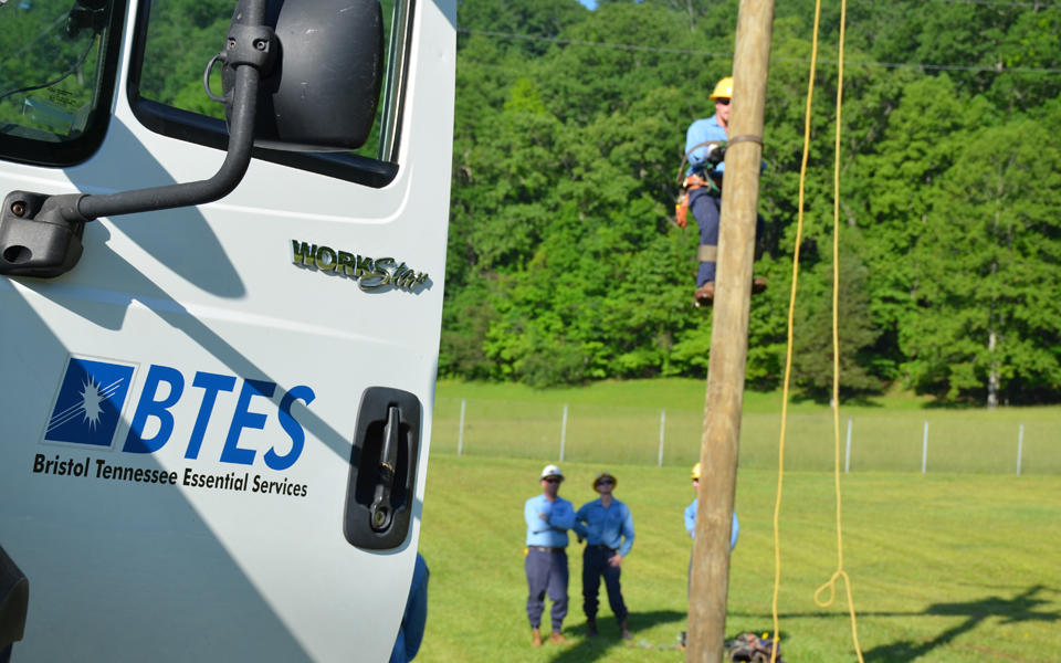 BTES of workforce on location climbing an electric pole.