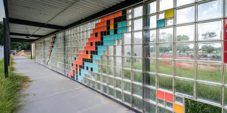 wall of multicolored glass bricks representing various isotopes 