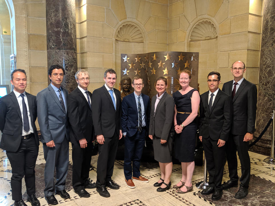 Nine award winners pose for a group photo