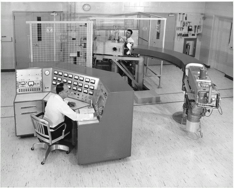 Two men in a room full of scientific equipment