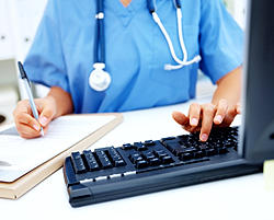 Healthcare worker at a computer