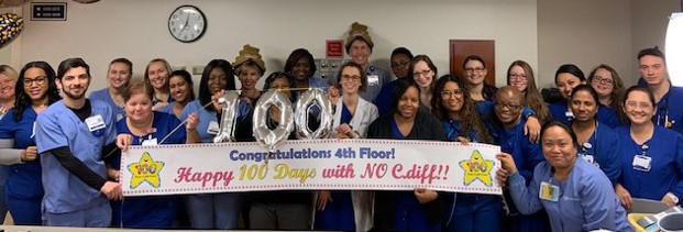 Duke Raleigh Hospital staff showing a sign that says celebrate 100 days with no instances of the hospital-acquired infection Clostridium difficile, also known as C.diff. Duke Raleigh Hospital staff showing a sign that says celebrate 100 days with no instances of the hospital-acquired infection Clostridium difficile, also known as C.diff.