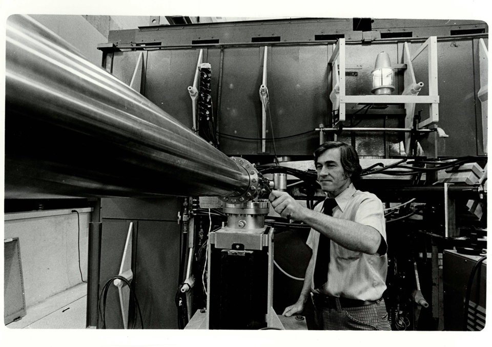 A man adjusts a fitting on a metal pipe