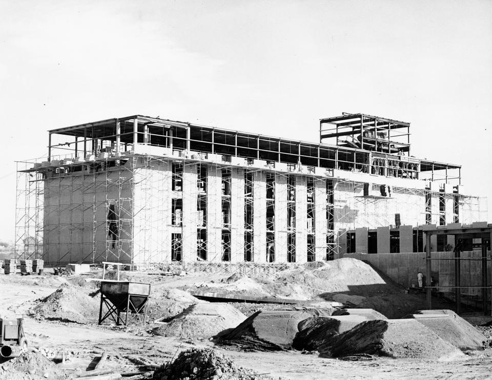 A building under construction is surrounded by scaffolding.