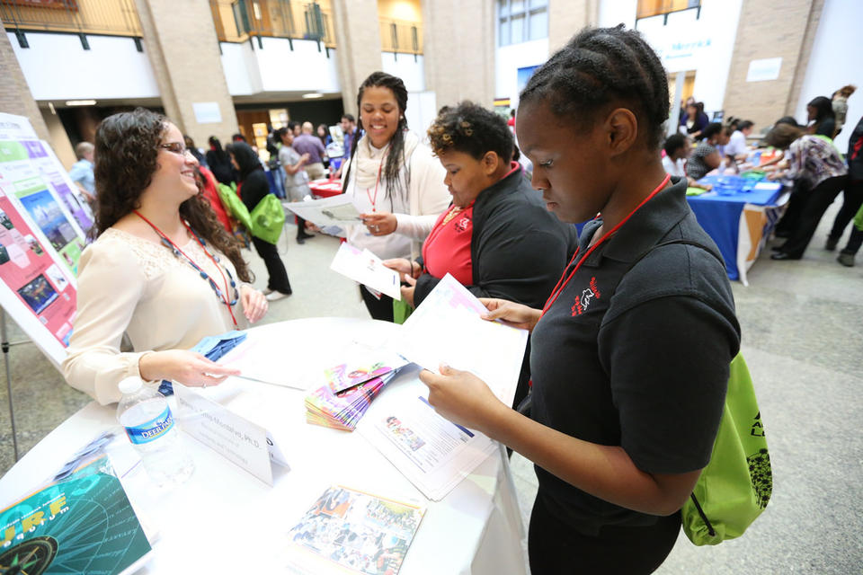 Minority students working at table