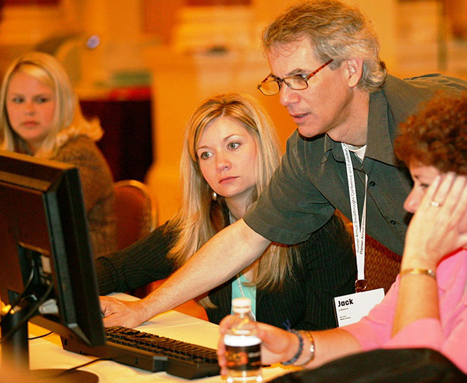 Premier, Inc., 2006 Malcolm Baldrige National Quality Award Recipient photo of people working on a computer.