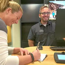 two ECU employees share a laugh in a candid photo