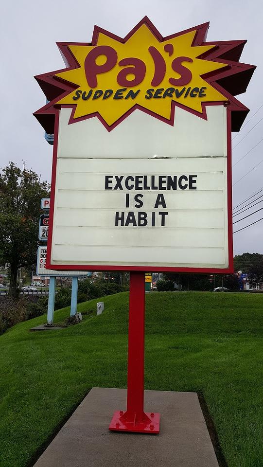 Photo of Pal's Sign That Says, "Excellence Is a Habit"