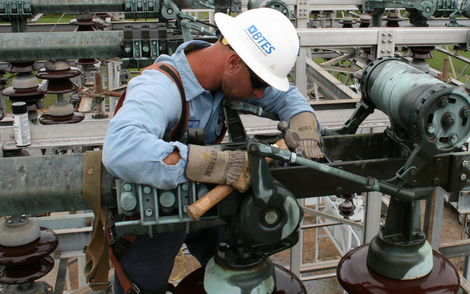 worker repairing an electrical line