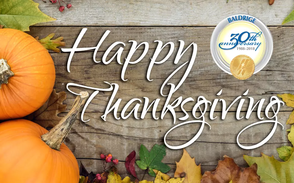 Happy Thanksgiving text with pumpkins and leaves in the background.