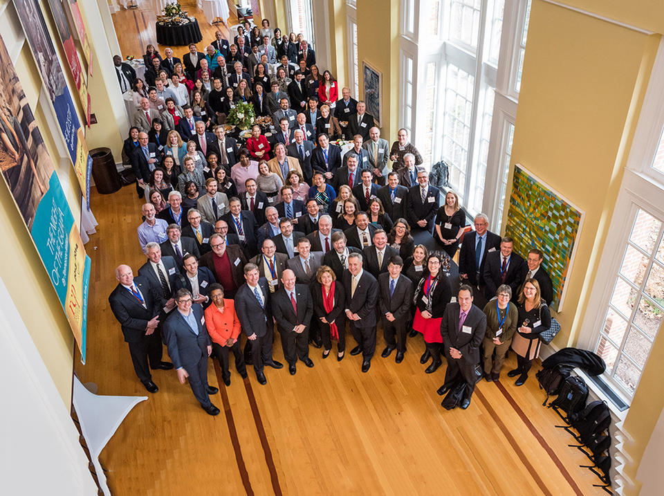 An overhead shot of a large group of people in a building lobby.