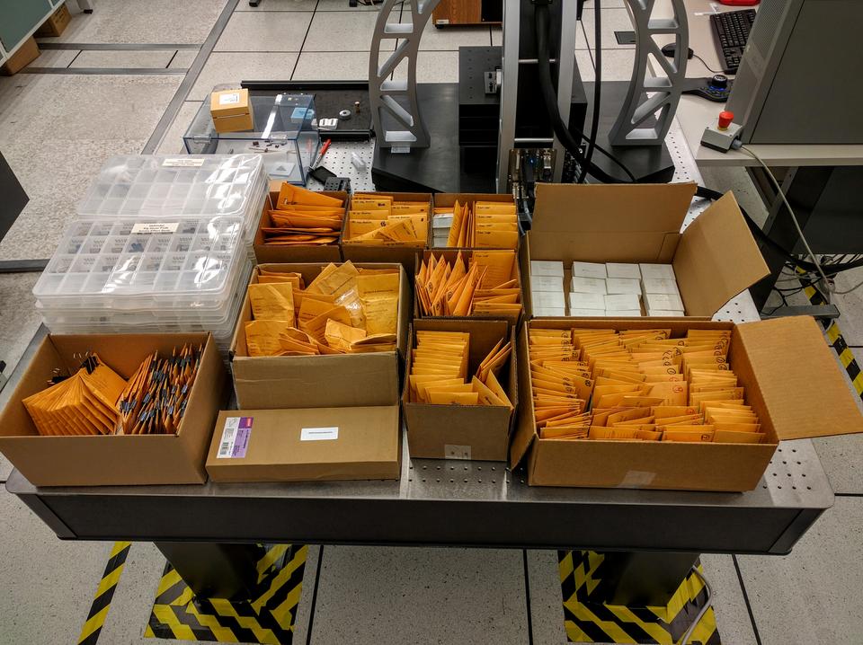 Boxes filled with yellow envelopes on a table.