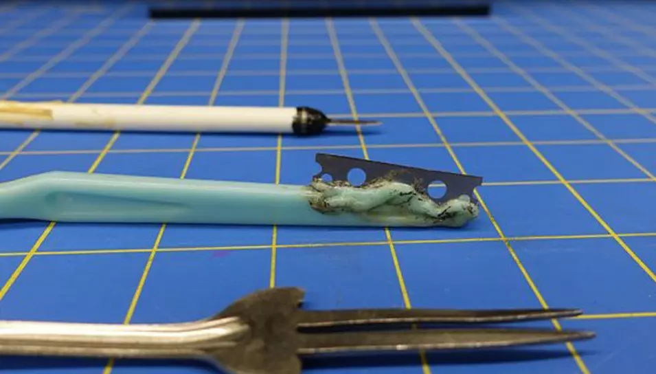 three weapons on a blue checked background