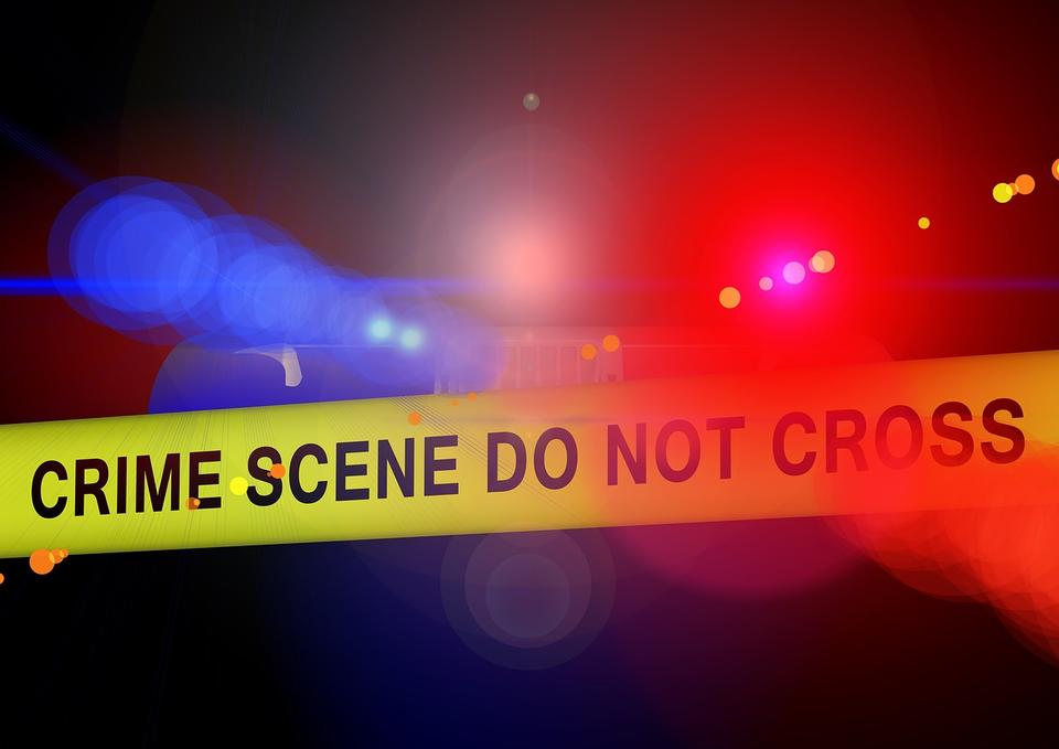 Crime scene tape with flashing police lights