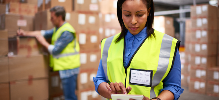 woman working on a tablet in a manufacturing facility