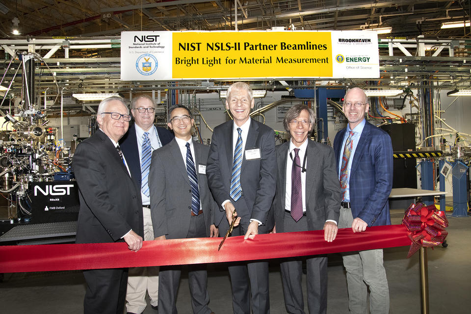 Group of executives performing ribbon cutting to open NIST beamlines at Brookhaven National Lab NSLS-II